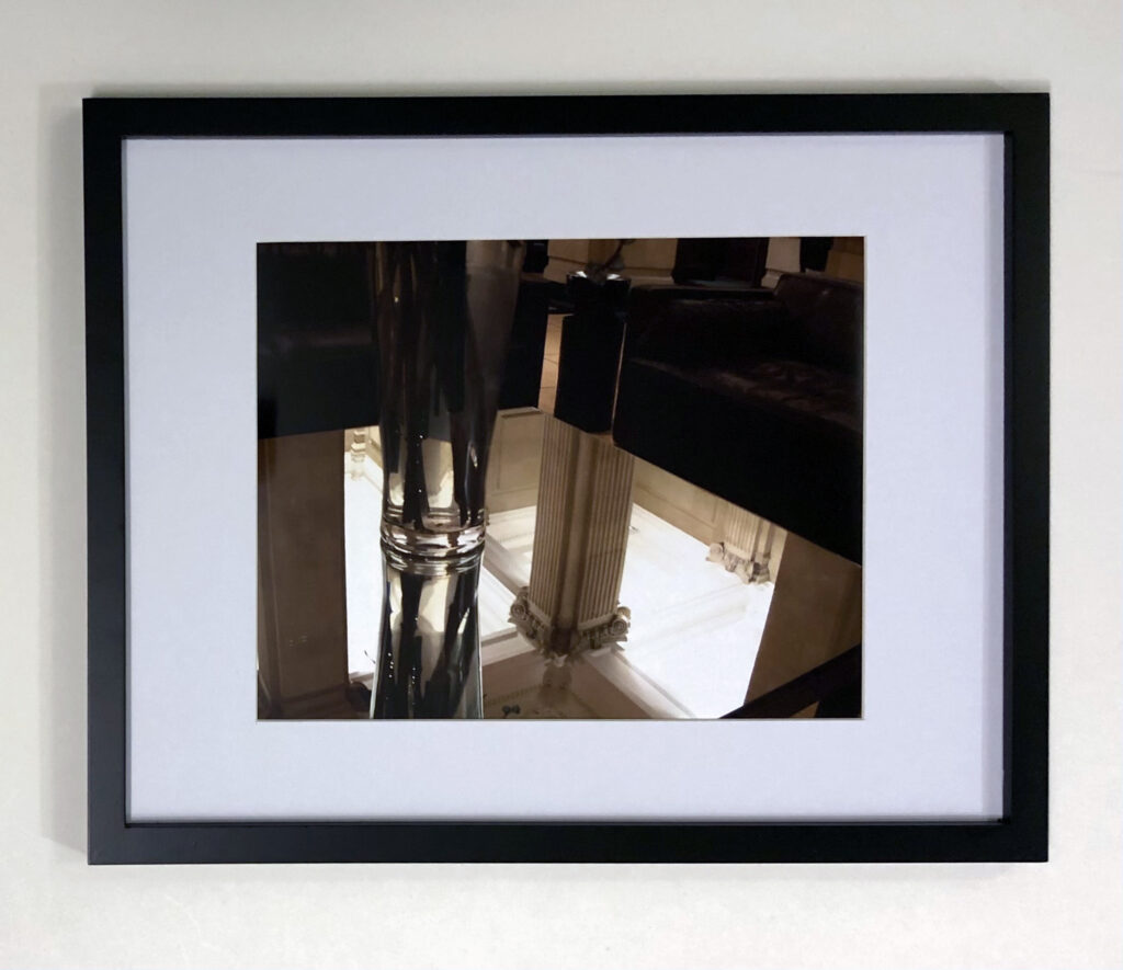 “Mirror Table” (2004), London, England. This 8” x 10” photograph was taken with a disposable camera, as I waited for hours in a lobby in Westminster. I was mesmerized by the reflection of this mirrored table. I thought it was interesting how the trash receptacle appeared to rise up out of the marble column. And the vase had an “as above, so below” vibe. Although I know the photograph only resonates so powerfully with me, it is one of my favorite photographs that I have ever taken.