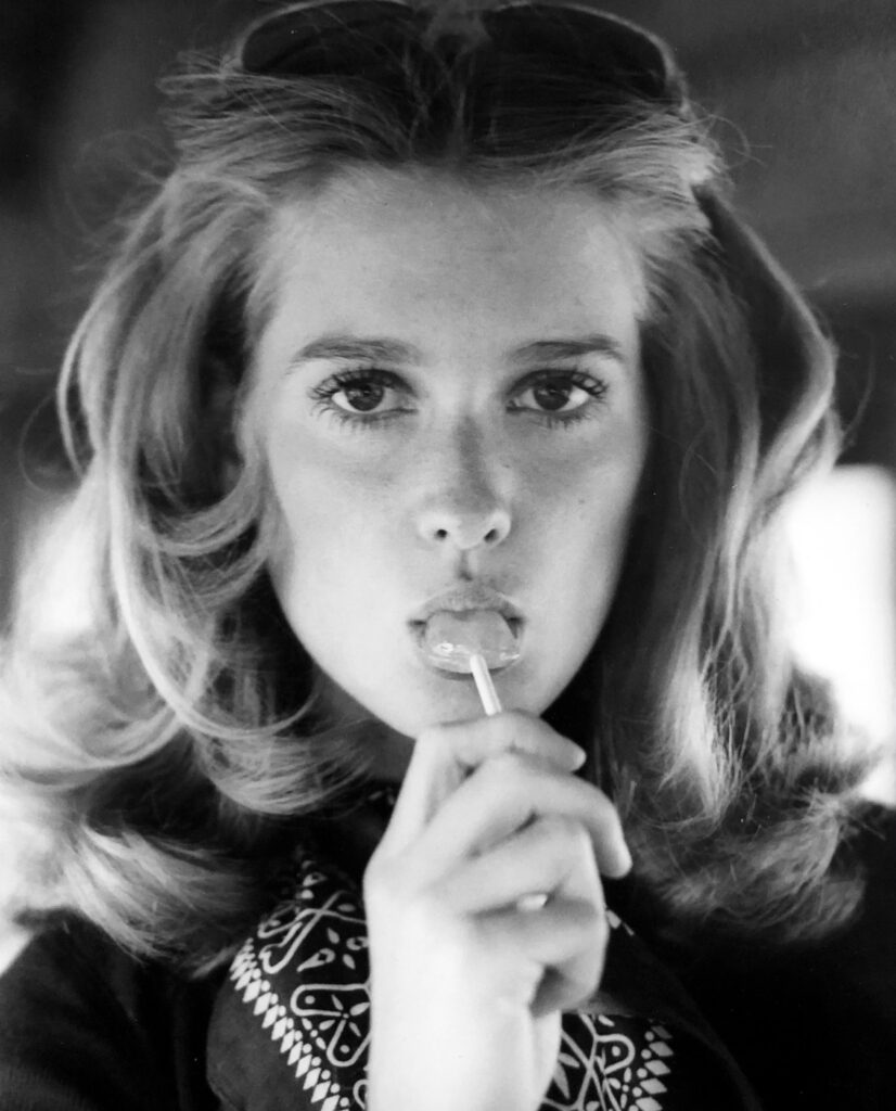 In this portrait of a model with a lollipop, photographer Doug Wilkins demonstrates his exceptional eye for capturing the perfect moment on film that draws the viewer in, while also conveying the personality of his subject.