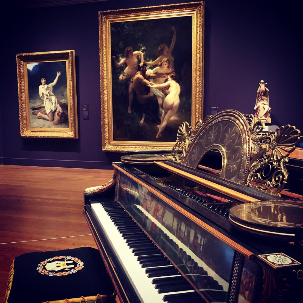 The painting “Nymphs and Satyr” by William-Adolphe Bouguereau hangs in the background in the gallery at The Clark Art Institute. Photo by Michael Aaron Gallagher.