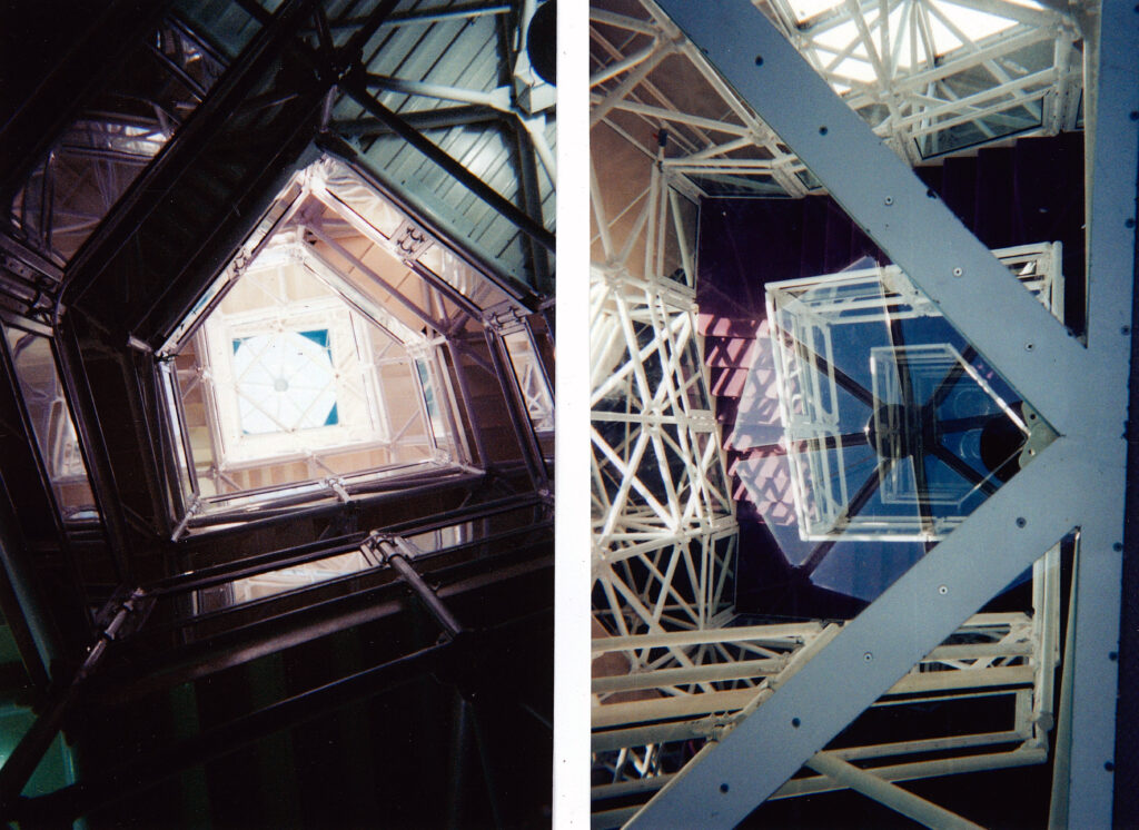 A view looking up the staircase to the tower of the Biosphere 2 Center (left) and a look through the glass floor from the library at the top to the ground floor below (right). Both photographs were taken by Michael Aaron Gallagher in 1998.