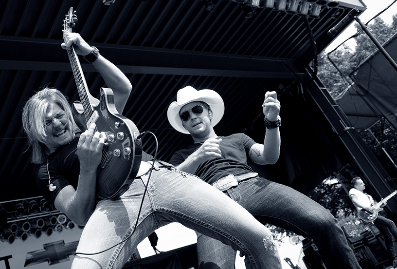 Justin Moore plays air guitar with Roger Coleman by Michael Aaron Gallagher