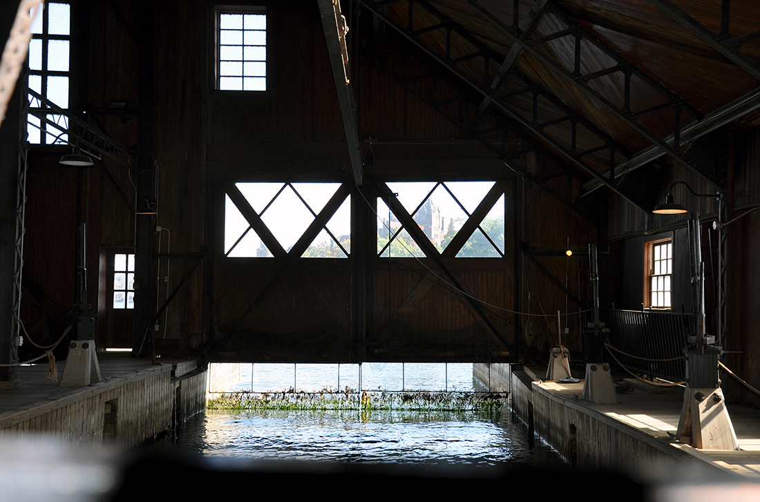 Interior bay inside Boldt Yacht House with a view of Boldt Castle in the distance by Michael Aaron Gallagher